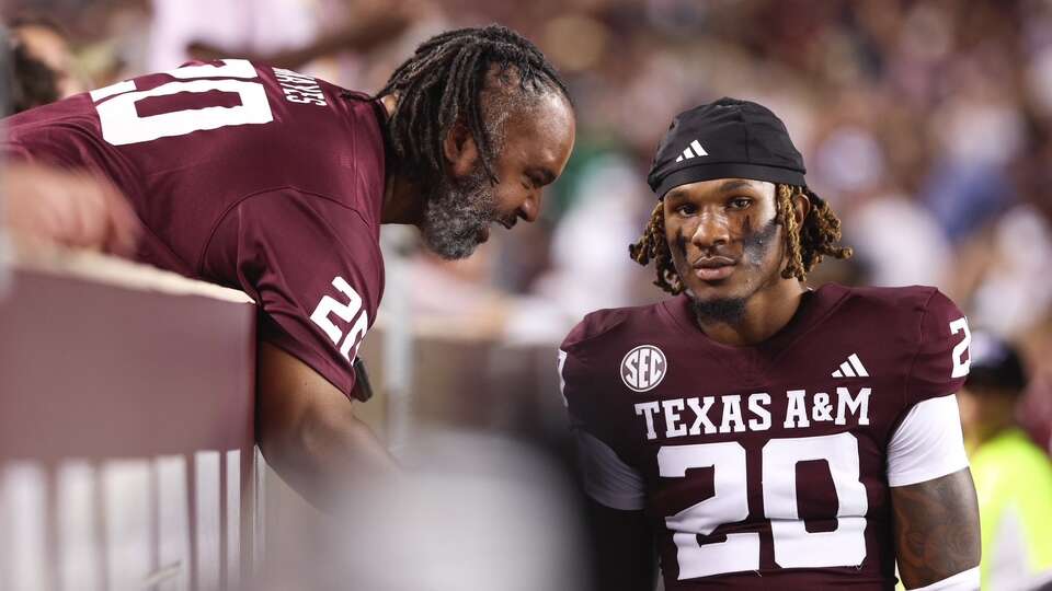 Brian and son BJ Mayes share a moment during A&M's season opener against Notre Dame