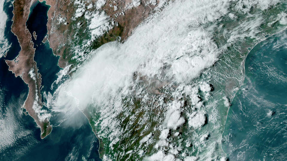 This satellite image provided by the U.S. National Oceanic and Atmospheric Administration shows Tropical Storm Ileana, left, near the coastal Mexican city of Topolobampo on the eastern side of the Gulf of California, on Sept. 14.