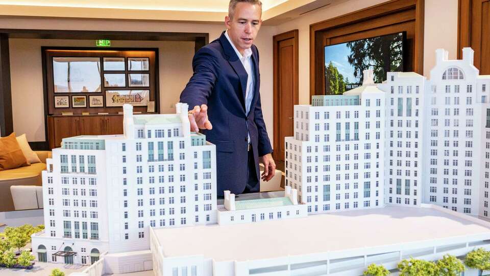 Howard Hughes Houston Region President Jim Carman refers to a scale architectural model Wednesday, Oct. 2, 2024, as he points out various features of the new The Ritz-Carlton Residences, The Woodlands development in The Woodlands.