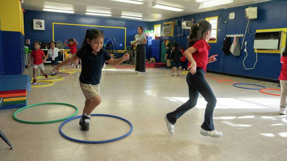 Pre-K students run around an obstacle course during a physical education class in a makeshift gym in a t-building at Cornelius Elementary School in Houston on September 25, 2024.