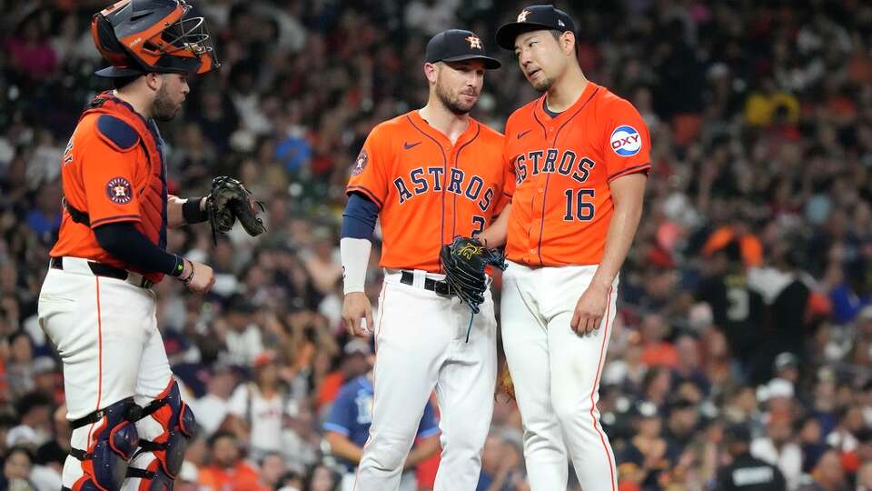 Houston Astros starting pitcher Yusei Kikuchi (16) chats with third baseman Alex Bregman (2) as manager Joe Espada (19) came out to pull him during the sixth inning of an MLB baseball game at Minute Maid Park on Friday, Aug. 2, 2024, in Houston.