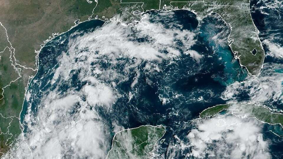 In this weather satellite photo of the Gulf of Mexico taken Thursday morning, Texas is easily seen with clear skies in the upper left. A tropical system in the Gulf of Mexico has only a 30% chance of developing into anything stronger, and whatever does develop is likely to be pushed eastward away from the Texas coast because of a cold front expected to swing past the state in the coming days.