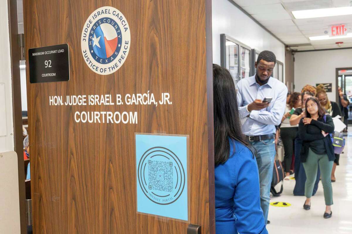 A line forms down the hallway outside Harris County Justice of the Peace (Precinct 5, Place 1) court Thursday, Oct. 3, 2024, as persons involved with eviction cases wait to appear before Judge Israel B. Garcia, Jr. in Houston.