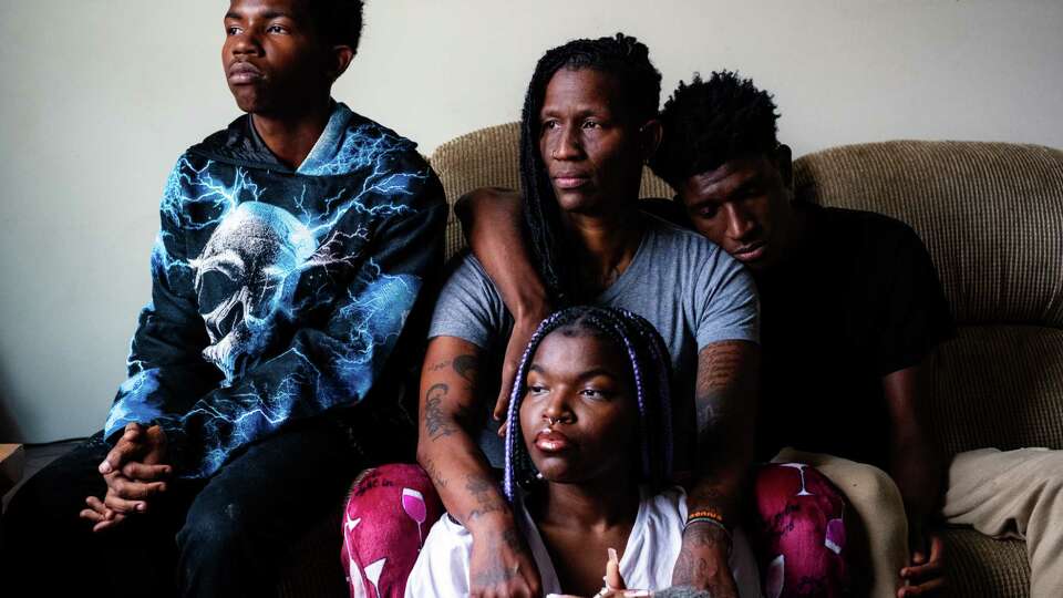 Durham, NC - Septembe 22nd, 2024: Lotus Wilson (center), a supporter of Vice President Kamala Harris run for President in the 2024 election, sits for a portrait at her home in Durham, North Carolina with her children Amir, Neha, and Nasir.(Cornell Watson/The Chronicle)