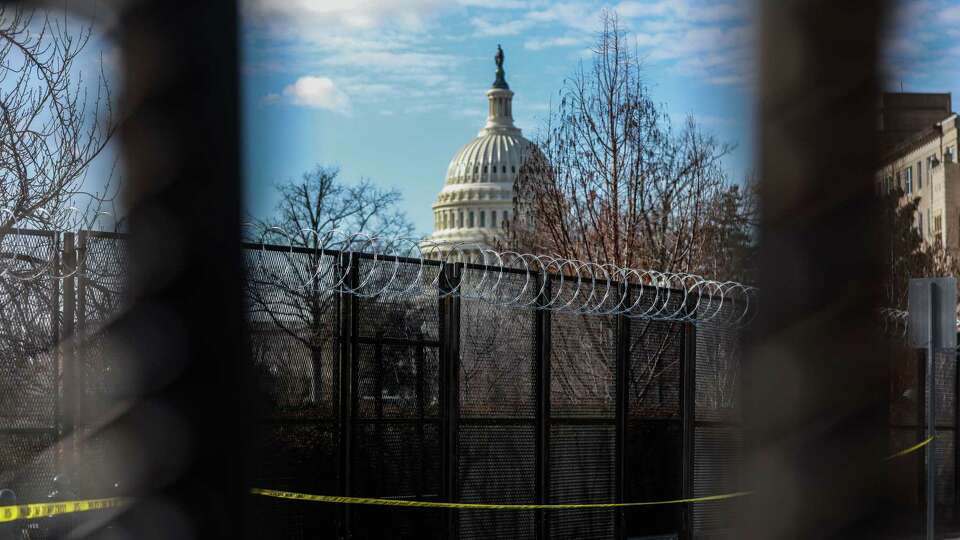 Barbed wire fencing is seen across a barricade in front of the U.S.Capitol ahead of the Presidential inauguration on Sunday, Jan. 17, 2021 in Washington, D.C.