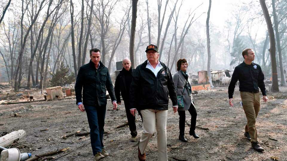 US President Donald Trump (C) walks with Paradise Mayor Jody Jones (2R), Governor of California Jerry Brown (2L), Administrator of the Federal Emergency Management Agency, Brock Long (R), and Lieutenant Governor of California, Gavin Newson, as they view damage from wildfires in Paradise, California on November 17, 2018. - President Donald Trump arrived in California to meet with officials, victims and the 'unbelievably brave' firefighters there, as more than 1,000 people remain listed as missing in the worst-ever wildfire to hit the US state. (Photo by SAUL LOEB / AFP)SAUL LOEB/AFP/Getty Images