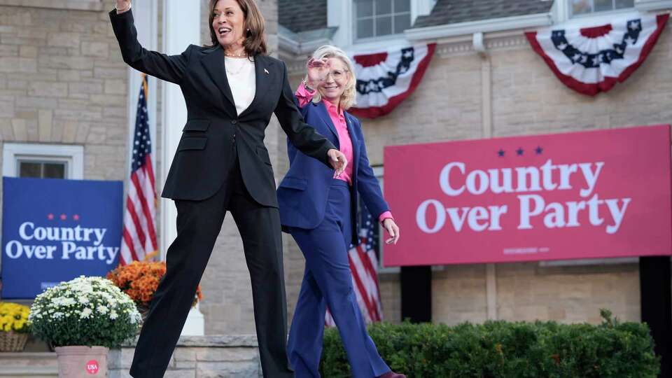 Democratic presidential nominee Vice President Kamala Harris, left, arrives to speak at a campaign event with former Congresswoman Liz Cheney, R-Wyo., right, at Ripon College in Ripon, Wis., Thursday, Oct. 3, 2024. (AP Photo/Mark Schiefelbein)