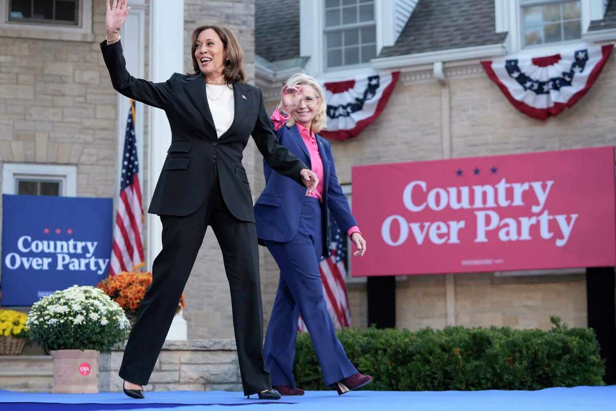 Democratic presidential nominee Vice President Kamala Harris, left, arrives to speak at a campaign event with former Congresswoman Liz Cheney, R-Wyo., right, at Ripon College in Ripon, Wis., Thursday, Oct. 3, 2024. (AP Photo/Mark Schiefelbein)