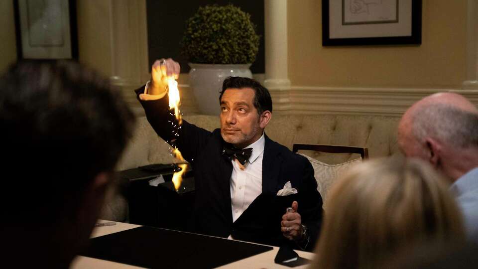 Christian Cagigal performs a cad trick involving fire at the Hotel Majestic’s Butterfly Lounge in San Francisco on Wednesday, October 2, 2024.