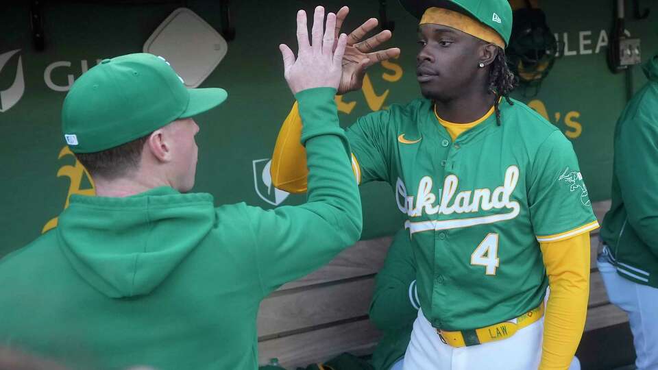 Oakland Athletics' Lawrence Butler (4) greets teammates before a baseball game against the Texas Rangers in Oakland, Calif., Wednesday, Sept. 25, 2024. (AP Photo/Jeff Chiu)