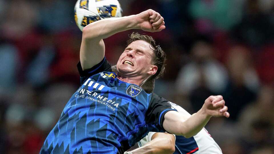 San Jose Earthquakes' Tanner Beason, left, vies for the ball during the second half of an MLS soccer match against the Vancouver Whitecaps in Vancouver, British Columbia, Saturday, Sept. 14, 2024. (Ethan Cairns/The Canadian Press via AP)