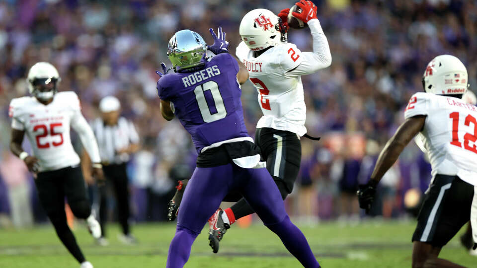 FORT WORTH, TX - OCTOBER 4: A.J. Haulcy #2 of the Houston Cougars intercepts as DJ Rogers #0 of the TCU Horned Frogs looks on during the first half at Amon G. Carter Stadium on October 4, 2024 in Fort Worth, Texas. (Photo by Ron Jenkins/Getty Images)