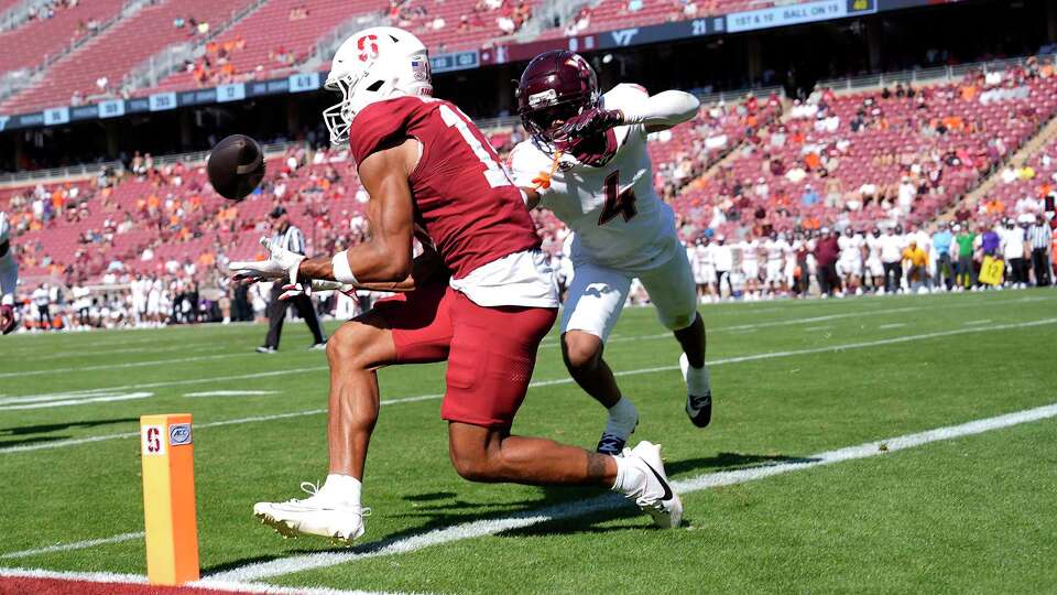 Stanford wide receiver Elic Ayomanor (13) catches a touchdown pass in front of Virginia Tech cornerback Mansoor Delane (4) throws a pass against Virginia Tech during the second half of an NCAA college football game Saturday, Oct. 5, 2024, in Stanford, California.