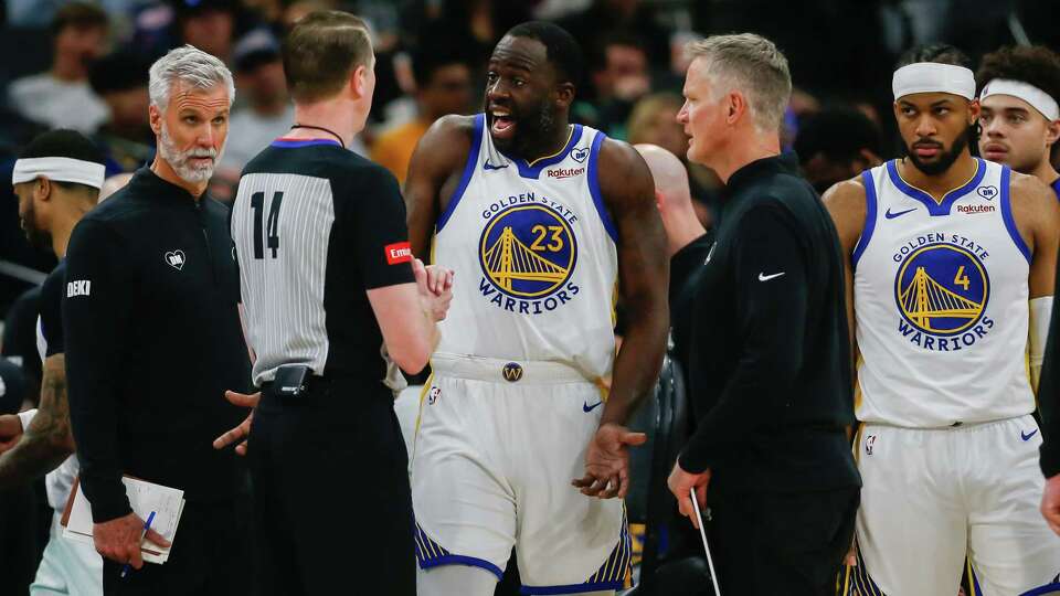 Golden State Warriors forward Draymond Green (23) argues with referee Ed Malloy (14) about an offensive foul called against him during the first half against the San Antonio Spurs at Frost Bank Center on Monday, March 11, 2024, in San Antonio, Texas. The Spurs fell to the Warriors, 112-102.