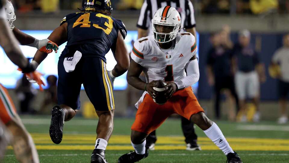 Miami quarterback Cam Ward (1) runs against California linebacker Ryan McCulloch (43) during the first half of an NCAA college football game in Berkeley, Calif., Saturday, Oct. 5, 2024. (AP Photo/Jed Jacobsohn)