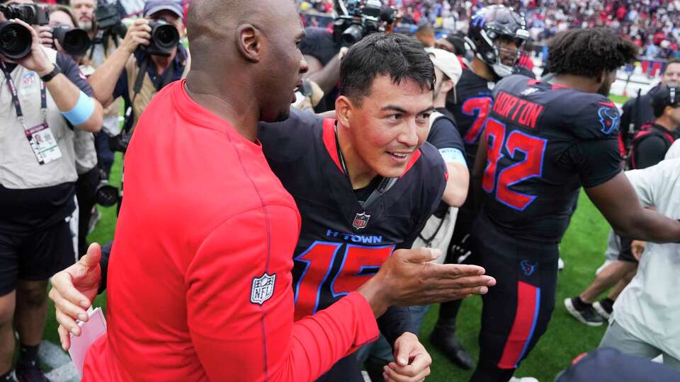 Houston kicker Ka'imi Fairbairn, center, visits with head coach DeMeco Ryans after hitting a game-winning, 59-yard field goal to give the Texans a 23-20 win over the Buffalo Bills during an NFL football game Sunday, Oct. 6, 2024, in Houston.