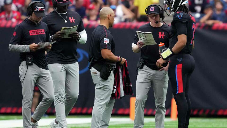 Houston Texans offensive coordinator Bobby Slowik talks with quarterback C.J. Stroud during the second half of an NFL football game Sunday, Oct. 6, 2024, in Houston.