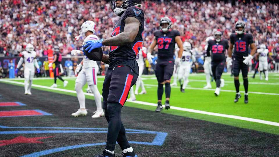 Houston Texans running back Cam Akers (22) celebrates his 15-yard touchdown run against the Buffalo Bills during the first half of an NFL football game Sunday, Oct. 6, 2024, in Houston.