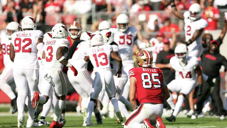 San Francisco 49ers’ George Kittle kneels after game-clinching interception by Arizona Cardinals’ Kyzir White in 4th quarter of Niners’ 24-23 loss in NFL game at Levi’s Stadium in Santa Clara, Calif., on Sunday, October 6, 2024.