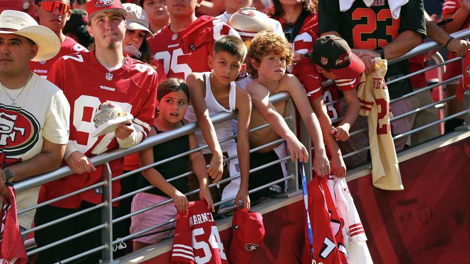 Young San Francisco 49ers’ fans wait for autographs in the heat before Niners play Arizona Cardinals during NFL game at Levi’s Stadium in Santa Clara, Calif., on Sunday, October 6, 2024.