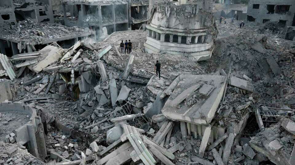 FILE - Palestinians inspect the rubble of the Yassin Mosque destroyed after it was hit by an Israeli airstrike at Shati refugee camp in Gaza City, early Monday, Oct. 9, 2023. Israel's military battled to drive Hamas fighters out of southern towns and seal its borders Monday as it pounded the Gaza Strip. (AP Photo/Adel Hana, File)