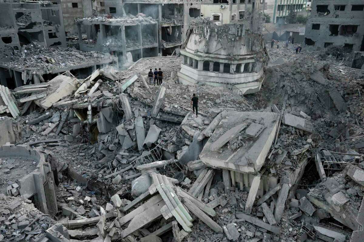 FILE - Palestinians inspect the rubble of the Yassin Mosque destroyed after it was hit by an Israeli airstrike at Shati refugee camp in Gaza City, early Monday, Oct. 9, 2023. Israel's military battled to drive Hamas fighters out of southern towns and seal its borders Monday as it pounded the Gaza Strip. (AP Photo/Adel Hana, File)