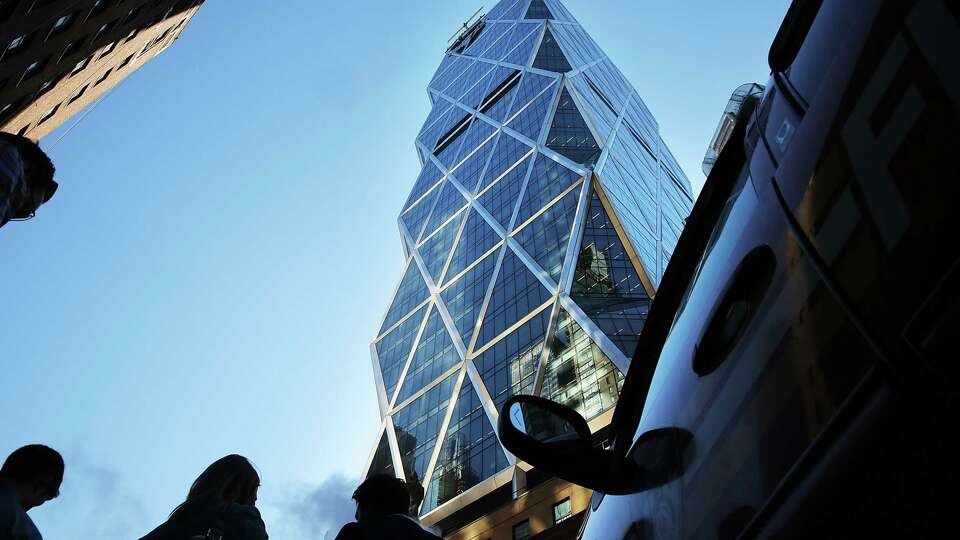 NEW YORK, NY - JUNE 12: People stand below broken scaffolding on the top of the 46-story Hearst Tower after two trapped window washers were rescued on June 12, 2013 in New York City. The workers, who were servicing the window-washing equipment when the scaffolding broke, were left dangling 500 feet above Eighth Avenue. Firefighters and NYPD emergency service unit officers were were able to rescue the men as hundreds of onlookers gazed up from the street.