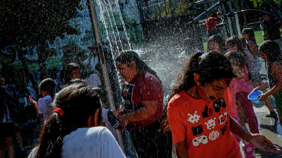 Kids cool off at a splash park near there Mission Playground in San Francisco on Tuesday, Oct. 1, 2024. It’s officially the city’s hottest day as temperatures creep up toward 100 degrees.