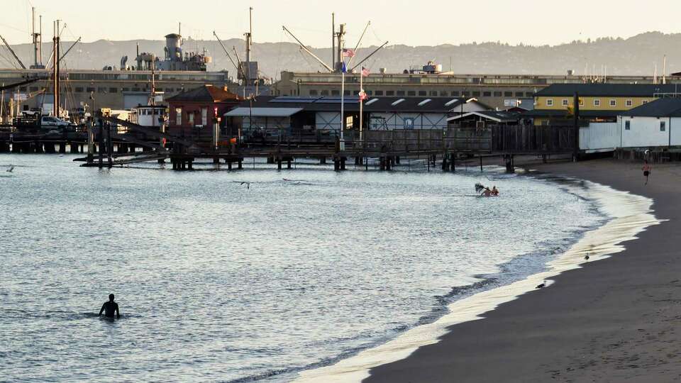 Swimmers emerge from the water on the shores of Aquatic Park in San Francisco, Calif. Tuesday, Nov. 29, 2022.