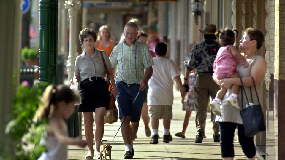 Shoppers make their way down Main Street in Fredericksburg on a Saturday morning. Over a million tourists invade the small Texas town each year.