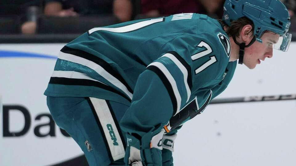 San Jose Sharks center Macklin Celebrini watches during a pre-season NHL hockey game against the Utah Hockey Club, Tuesday, Oct. 1, 2024, in San Jose, Calif. (AP Photo/Godofredo A. Vásquez)