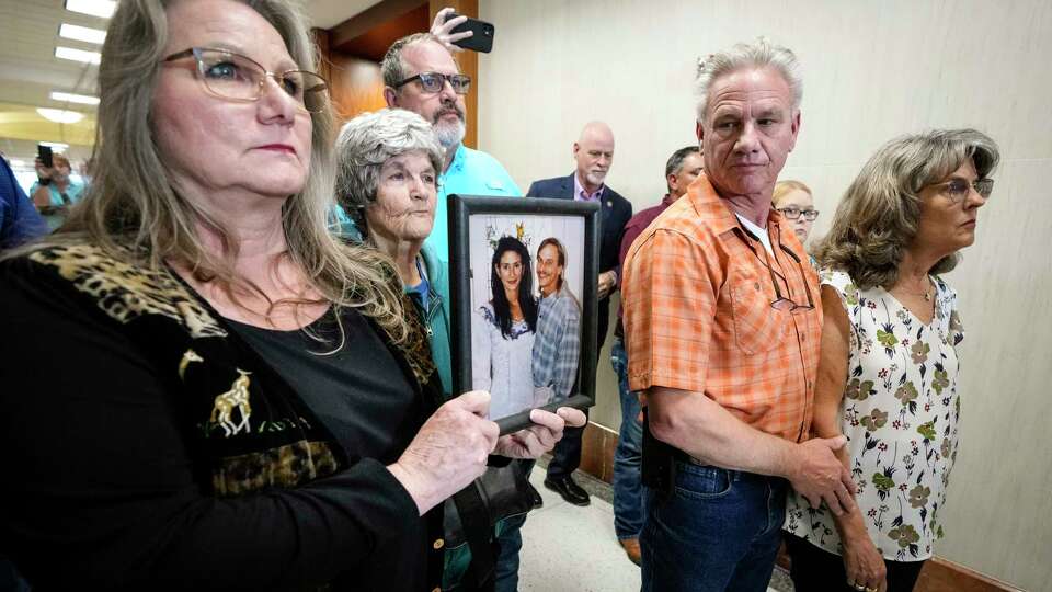 Elizabeth Ferrari, sister of Dennis Tuttle, holds a photo of her brother and Rhogena Nicholas, outside the courtroom after former Houston police officer Gerald Goines was sentenced to 60 years behind bars on a pair of felony murder convictions on Tuesday, Oct. 8, 2024 in Houston. Goines was found guilty of felony murder in the 2019 deaths of Tuttle and Nicholas.