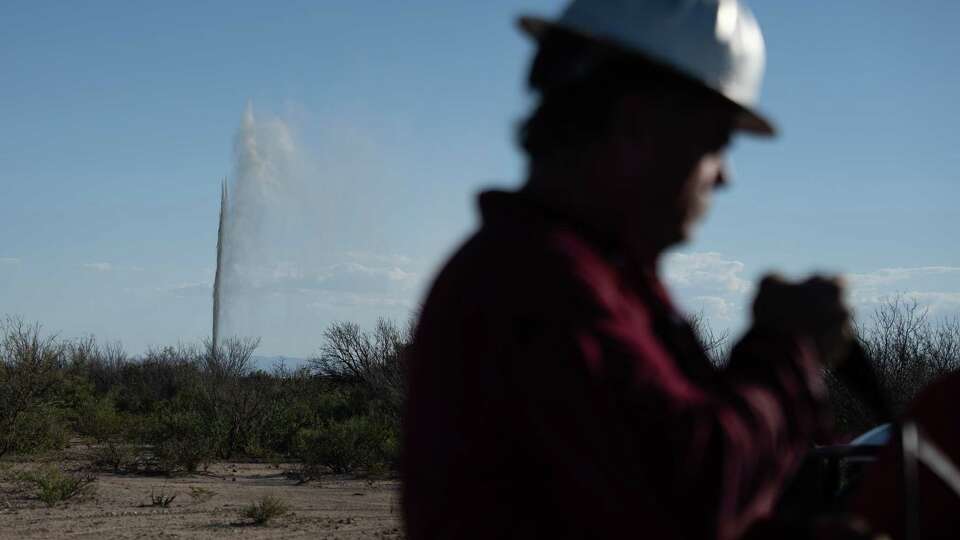 Well control specialist Hawk Dunlap puts away his protective gear after checking out a geyser of salty water and oil as it spews out near a dry hole on Wednesday, Oct. 2, 2024 in Toyha, Texas.