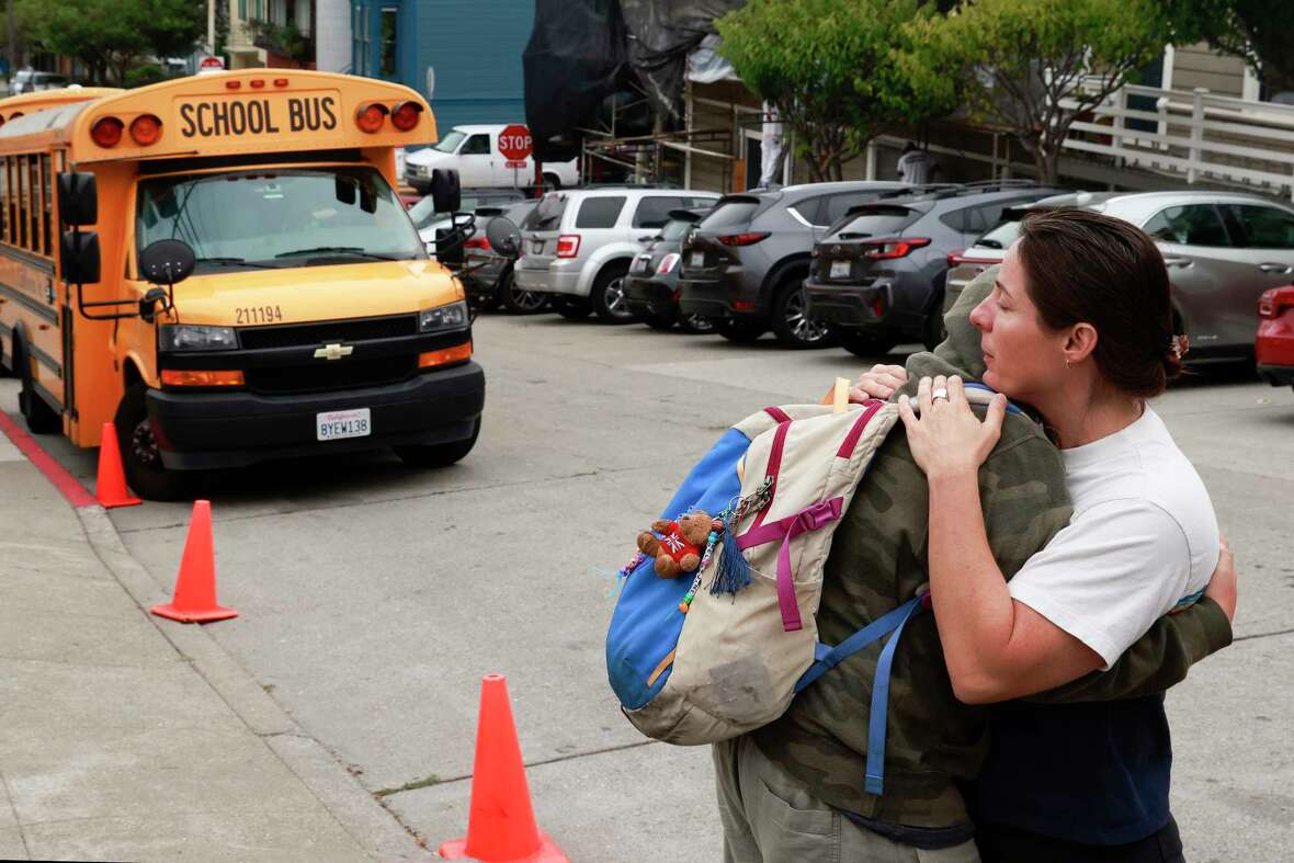 Arabella Hester hugs her fifth grade daughter Bella Jane following the news the school will be closing along with 11 other schools in San Francisco, Calif. Wednesday, October 9, 2024.