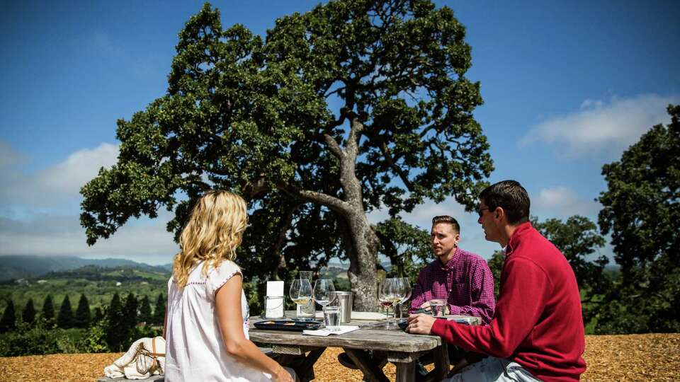 Michael Armstrong, center, leads a tasting for Millie Gort, left, and Jeff Blomquist, right, of Boulder, Colorado at Copain Wines in Healdsburg, California on June 28, 2017.