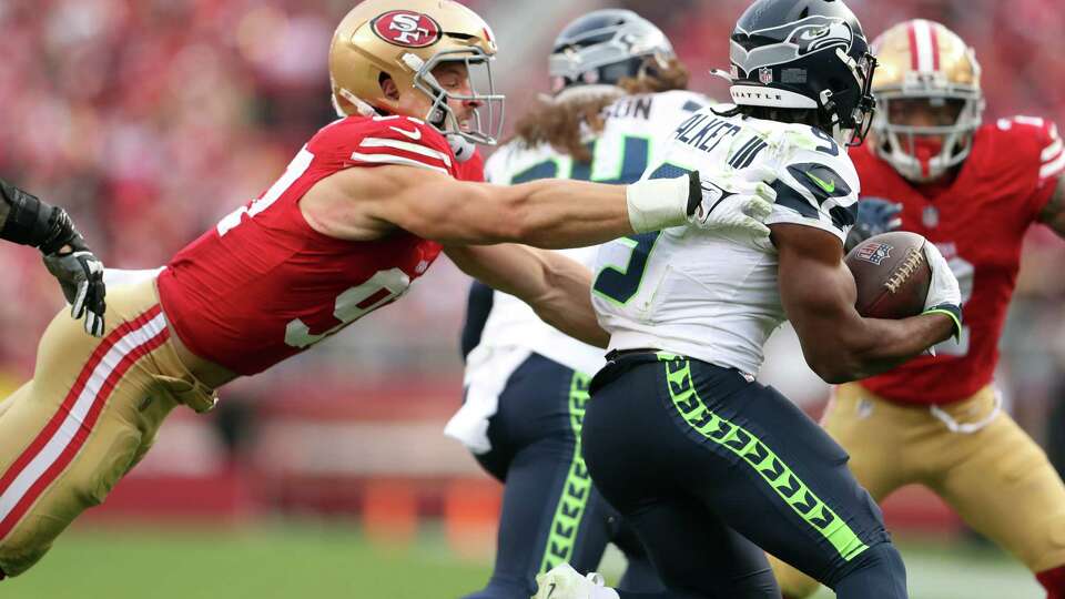 San Francisco 49ers’ Nick Bosa tries to tackle Seattle Seahawks’ Kenneth Walker III during Niners’ 28-16 win in NFL game at Levi’s Stadium in Santa Clara on Sunday, December 10, 2023.