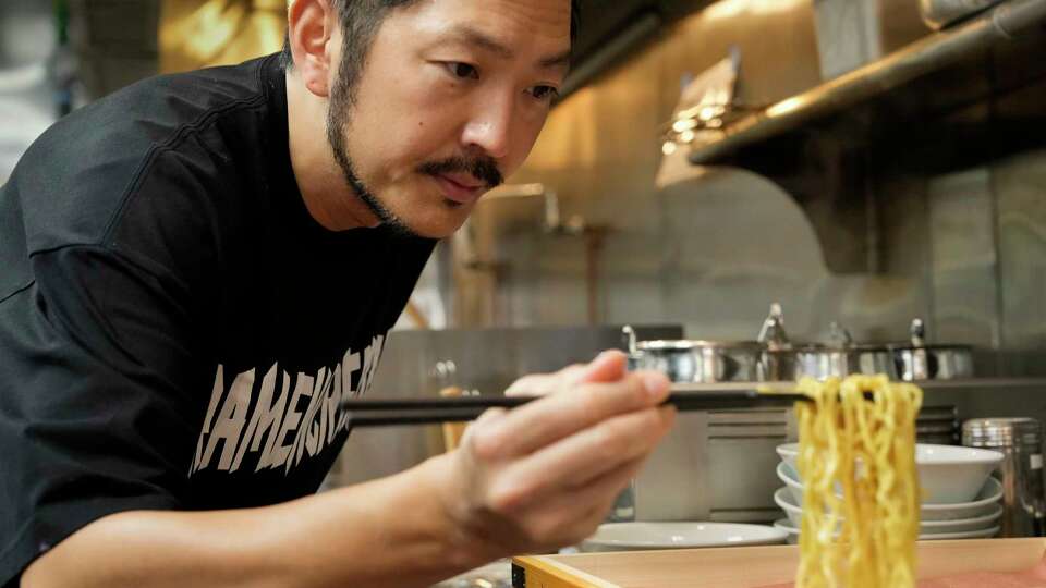 Ramen Master and Mensho Founder Tomoharu Shono makes sure the noodles are right while making a bowl of ramen Tuesday, Oct. 8, 2024 at Asiatown in Houston.