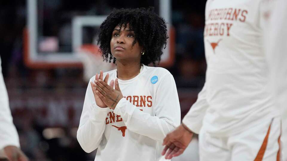 Texas guard Rori Harmon watches teammates warm up for a second-round college basketball game against Alabama in the women's NCAA Tournament in Austin, Texas, Sunday, March 24, 2024. The Texas Longhorns lost standout point guard Rori Harmon to a knee injury in December. Instead of slinking into the shadows of a long recovery for next season, Harmon has been team cheerleader, unofficial assistant coach and invaluable mentor for freshman Madison Booker, who took over the offense in her place and has the No. 1 seed Longhorns roaring into the Sweet 16. (AP Photo/Eric Gay)