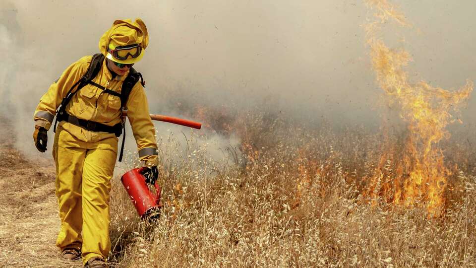 Jocelyn Fierro with the California State Parks’ Diablo Range District ignites vegetation with a drip torch during a 30-acre prescribed fire in the Mitchell Canyon area of Mount Diablo State Park in Clayton, Calif. Wednesday, May 15, 2024. The two day event, with personnel drawn from various park districts in Northern California and members of the Central Coast Prescribed Burn Association, is the first prescribed fire within Mount Diablo State Park in almost two decades with the goal to reduce fuel load in the wildland-urban interface and manage growth of invasive species for better biodiversity.