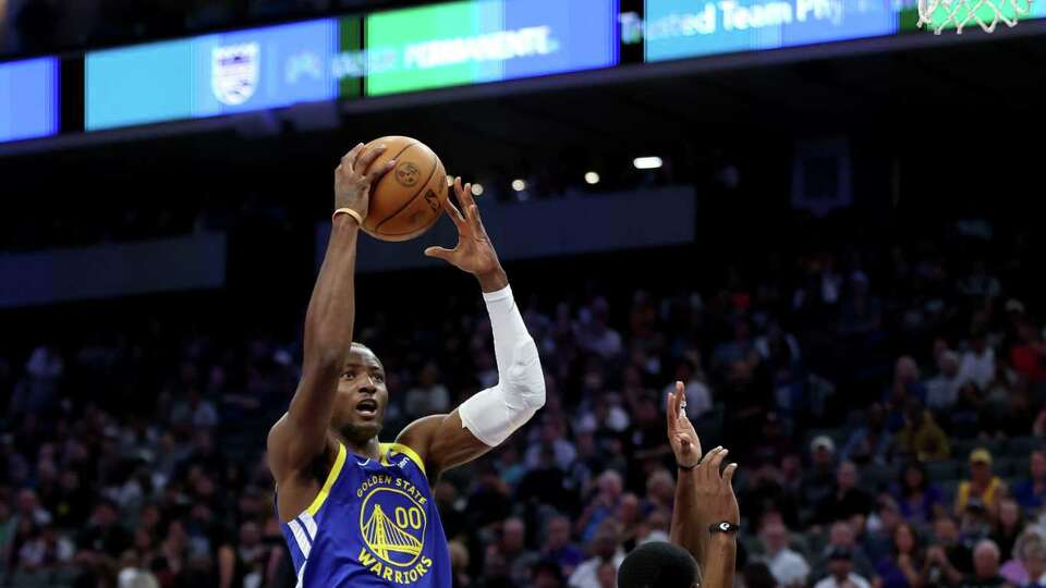 SACRAMENTO, CALIFORNIA - OCTOBER 09: Jonathan Kuminga #00 of the Golden State Warriors goes up for a shot on De'Aaron Fox #5 of the Sacramento Kings during their preseason game at Golden 1 Center on October 09, 2024 in Sacramento, California. NOTE TO USER: User expressly acknowledges and agrees that, by downloading and/or using this photograph, user is consenting to the terms and conditions of the Getty Images License Agreement.