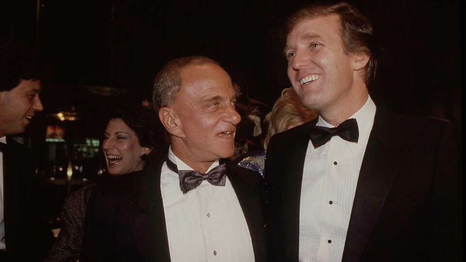 Roy Cohn, left, and Donald Trump attend the Trump Tower opening in October 1983 at The Trump Tower in New York City.