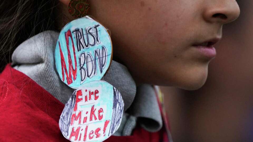 A Houston ISD student wears hand-made earrings against the Houston ISD $4.4 million bond during the district's board of managers meeting at the Hattie Mae White Educational Support Center, Thursday, Oct.10, 2024, in Houston.