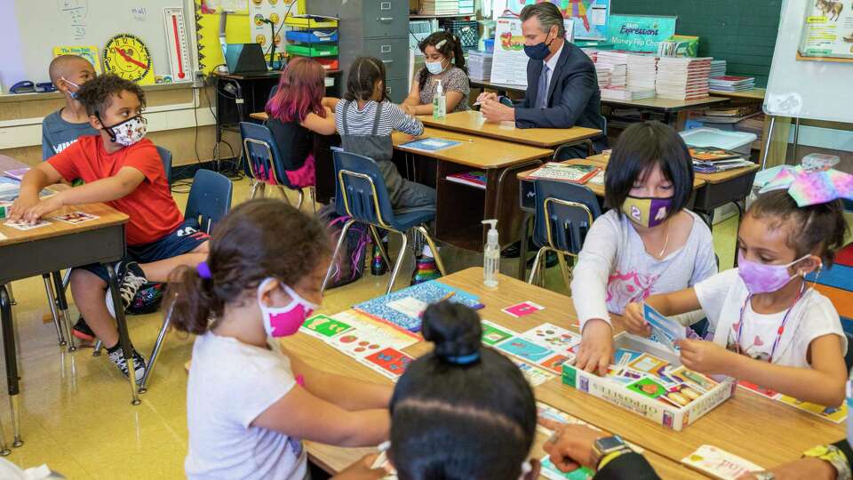 California Gov. Gavin Newsom visits Carl B. Munck Elementary School, Wednesday, Aug. 11, 2021, in Oakland, Calif. The governor announced that California will require its 320,000 teachers and school employees to be vaccinated against the novel coronavirus or submit to weekly COVID-19 testing.