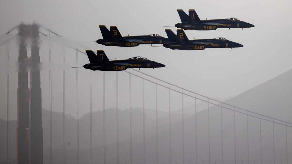 F/A-18 Super Hornets belonging to the U.S. Navy Flight Demonstration Squadron, the Blue Angels, fly in formation during a practice flight ahead of San Francisco Fleet Week, as seen from the Fairmont Hotel, in San Francisco, Thursday, Oct. 10, 2024.