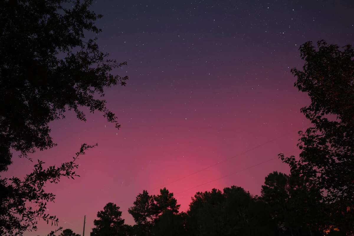 The sky over Conroe glowed a faint red on Thursday night after strong geomagnetic storm triggered the northern lights further south than they are normally seen. 