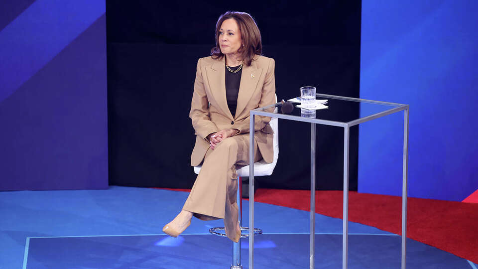 Democratic presidential nominee Vice President Kamala Harris takes a seat during a commercial break while engaging with Latino voters at a town hall organized by Noticias Univision at Cox Pavilion on the UNLV campus in Las Vegas on Thursday, Oct. 10, 2024.