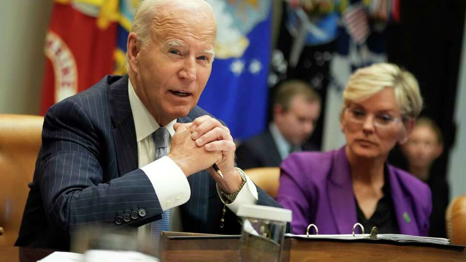 President Joe Biden speaks about the federal government's response to Hurricanes Milton and Helene as as Energy Secretary Jennifer Granholm listens, in the Roosevelt Room of the White House, Friday, Oct. 11, 2024, in Washington.