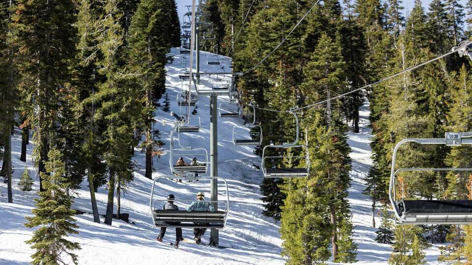 A group of snowboarders ride the Old Homewood Express while enjoying a sunny spring day at Homewood Resort.