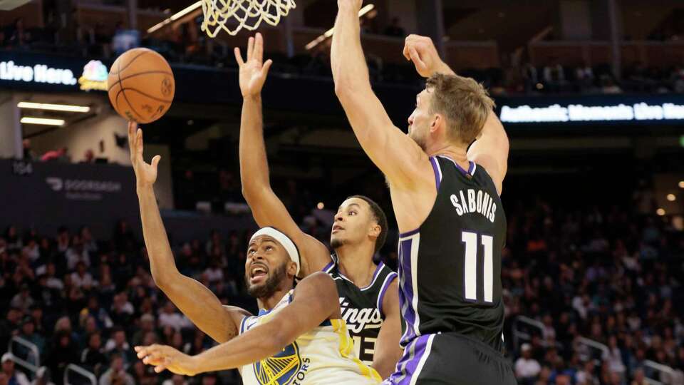 Golden State Warriors guard Moses Moody (4) is fouled as he attempts a lay up against the Sacramento Kings in the second quarter during an NBA preseason game at Chase Center in San Francisco, Friday, Oct. 11, 2024.