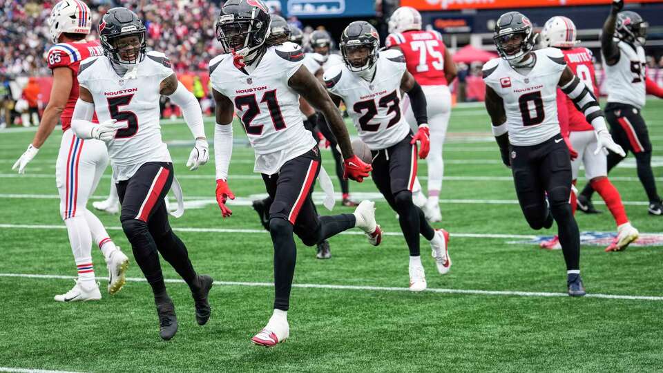 Houston Texans safety Calen Bullock (21) runs up the field celebrating his interception of a pass by New England Patriots quarterback Drake Maye during the first half of an NFL football game Sunday, Oct. 13, 2024, in Foxborough, Mass.